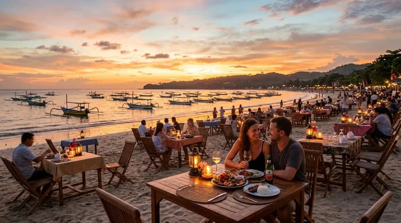 Pantai Jimbaran Bali dengan meja makan seafood di tepi pantai saat sunset
