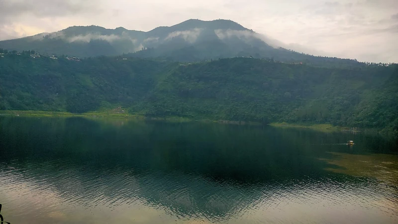 Telaga Menjer di Garung, Wonosobo, dengan perbukitan hijau berselimut awan rendah