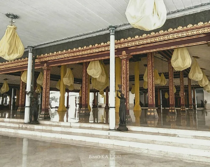 Pendhapa Ageng Sasana Sewaka di Keraton Surakarta dengan tiang-tiang berukir, lantai marmer, dan lampu gantung berselubung kain kuning